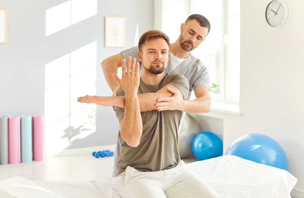 Massage therapist assisting with guided stretching to enhance flexibility, relieve joint tension, and promote overall muscle recovery – Massage in Juneau AK
