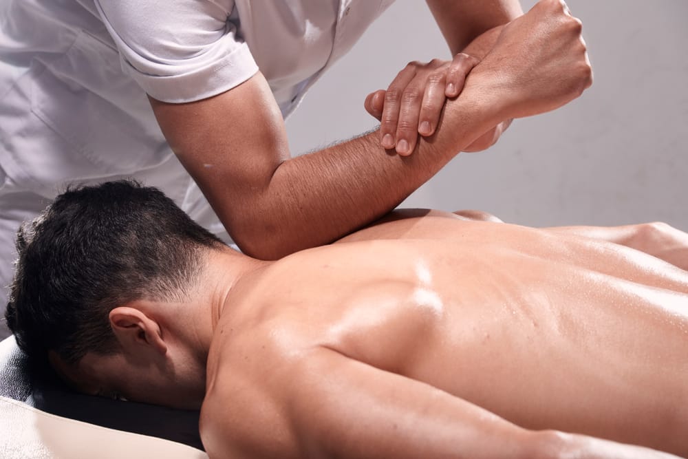 Massage therapist applying deep tissue pressure to relieve muscle tension, reduce soreness, and support full-body pain relief – Massage in Juneau AK